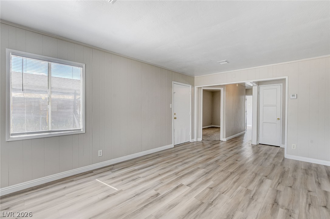 214 West Victory Road Henderson, NV 89015 - Photo 11 of 33 Luxury Vinyl flooring extends throughout this naturally illuminated living space, offering clear sightlines into adjacent rooms.
