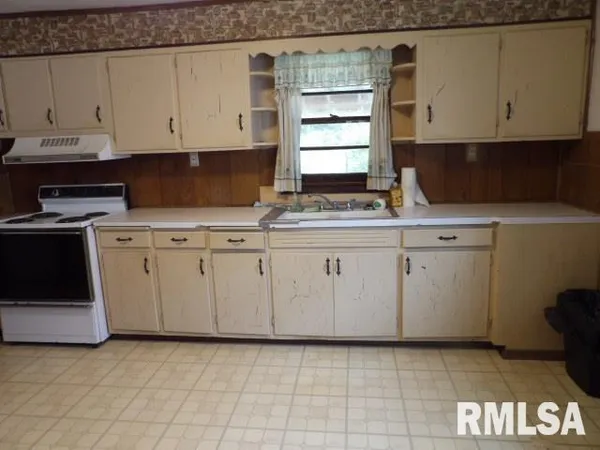 a kitchen with white cabinets