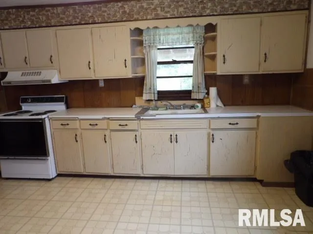 a kitchen with white cabinets