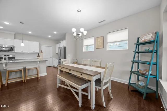 a kitchen with a sink appliances and wooden floor