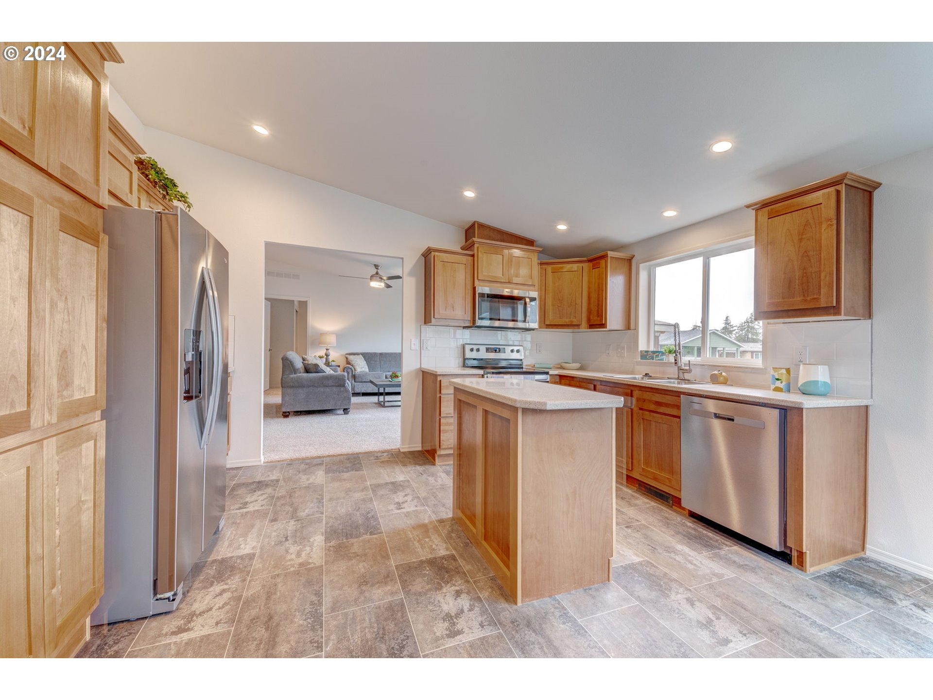 2417 Maia Loop Springfield, OR 97477 - Photo 9 of 21 a kitchen with stainless steel appliances granite countertop a refrigerator a sink a stove and oven