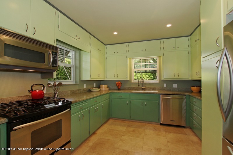 241 Orange Grove Road Palm Beach, FL 33480 - Photo 5 of 10 a kitchen with stainless steel appliances a sink stove and cabinets