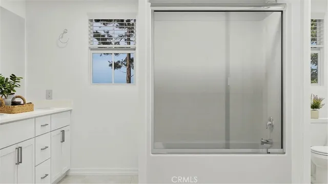 a bathroom with a shower and a sink