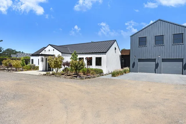 a view of a house with a yard and sitting area