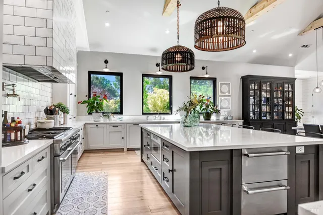 a kitchen with stainless steel appliances granite countertop a stove and a sink