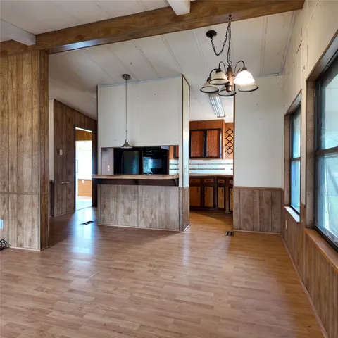 a view of kitchen and kitchen with furniture wooden floor and window