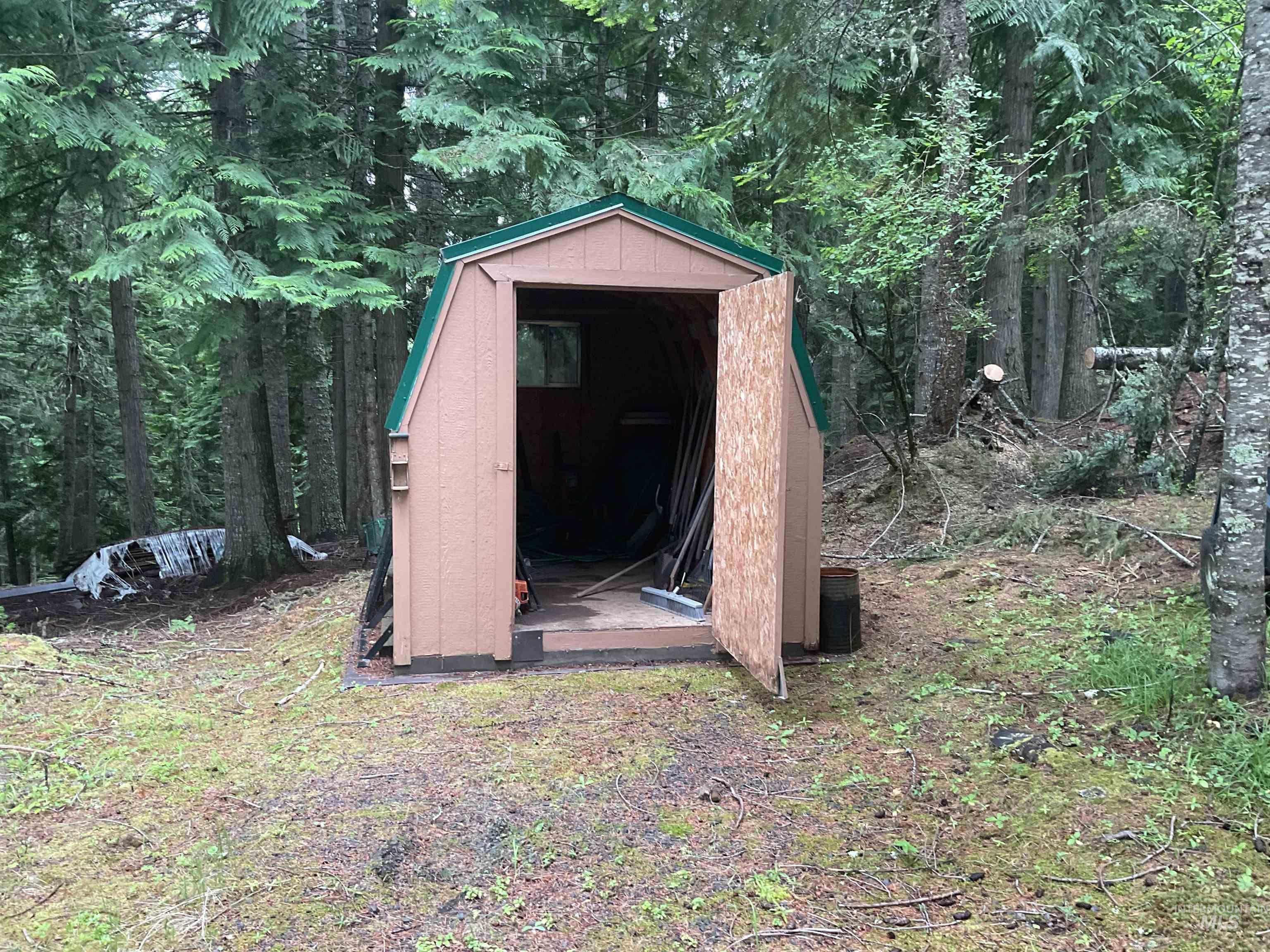 6125 Freeman Creek Road Lenore, ID 83541 - Photo 44 of 44 Wood-sided shed with a gambrel roof and green trim
