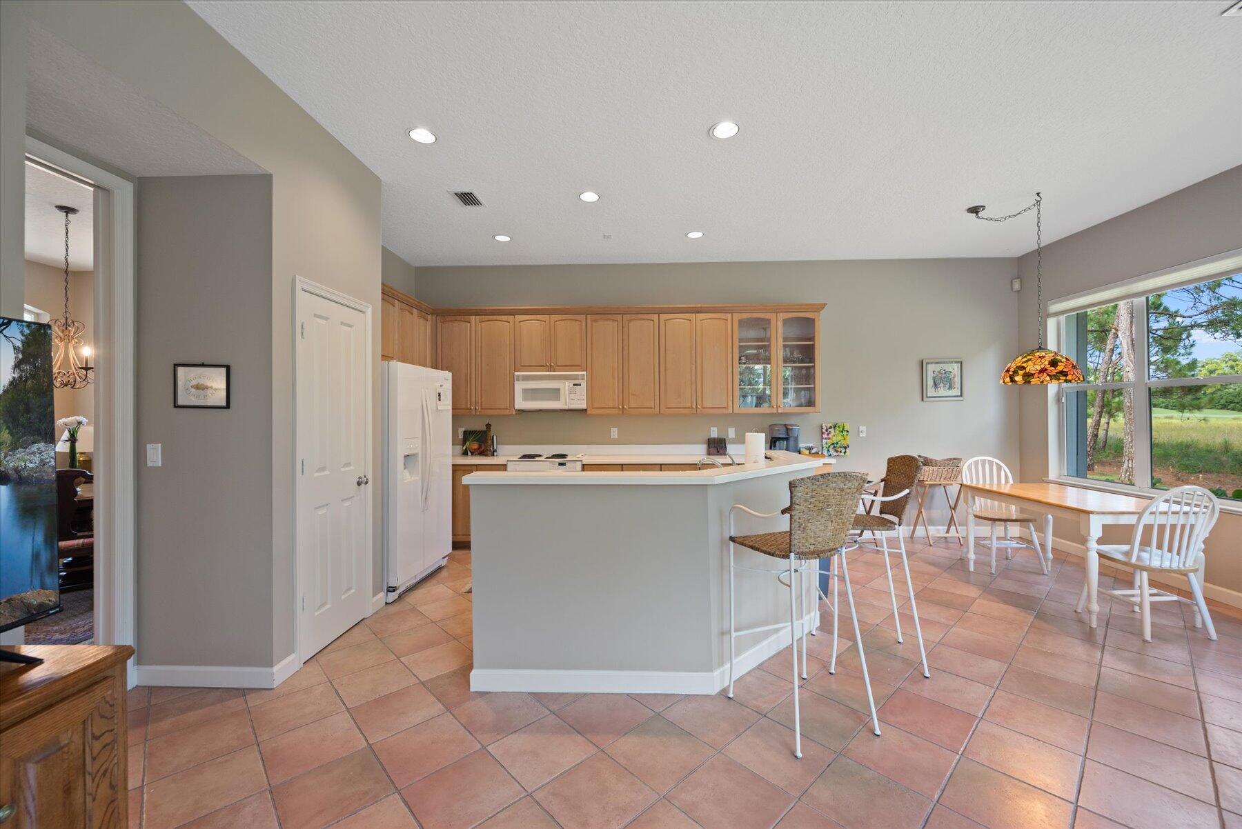 3498 Southeast Doubleton Drive Stuart, FL 34997 - Photo 17 of 42 a large kitchen with a table and chairs in it