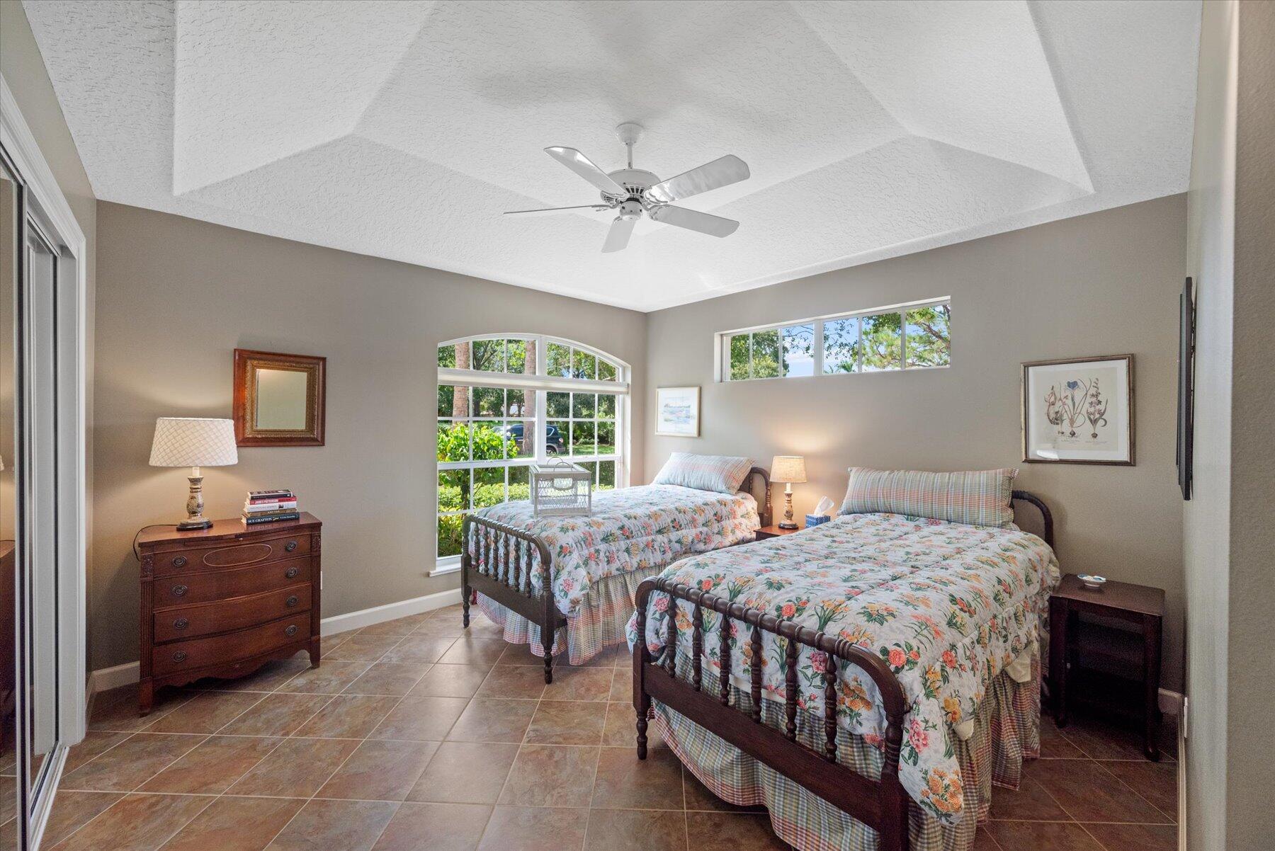 3498 Southeast Doubleton Drive Stuart, FL 34997 - Photo 21 of 42 a bedroom with a bed and a table in it with window