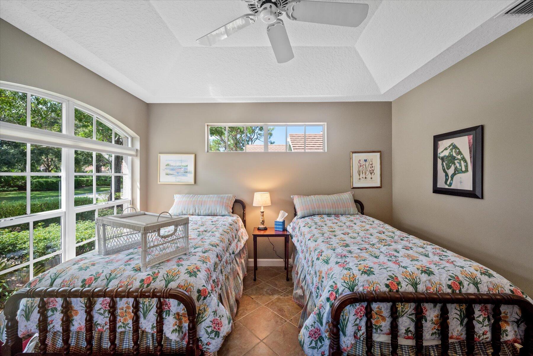 3498 Southeast Doubleton Drive Stuart, FL 34997 - Photo 22 of 42 a bedroom with two beds and a window