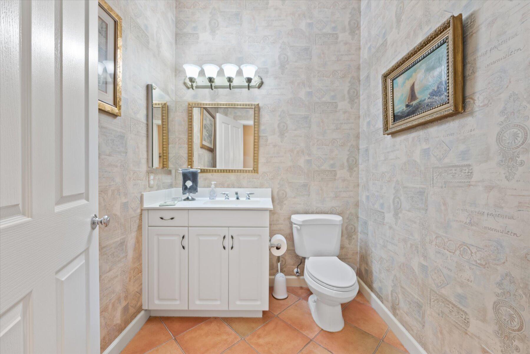 3498 Southeast Doubleton Drive Stuart, FL 34997 - Photo 25 of 42 a bathroom with a toilet sink and mirror