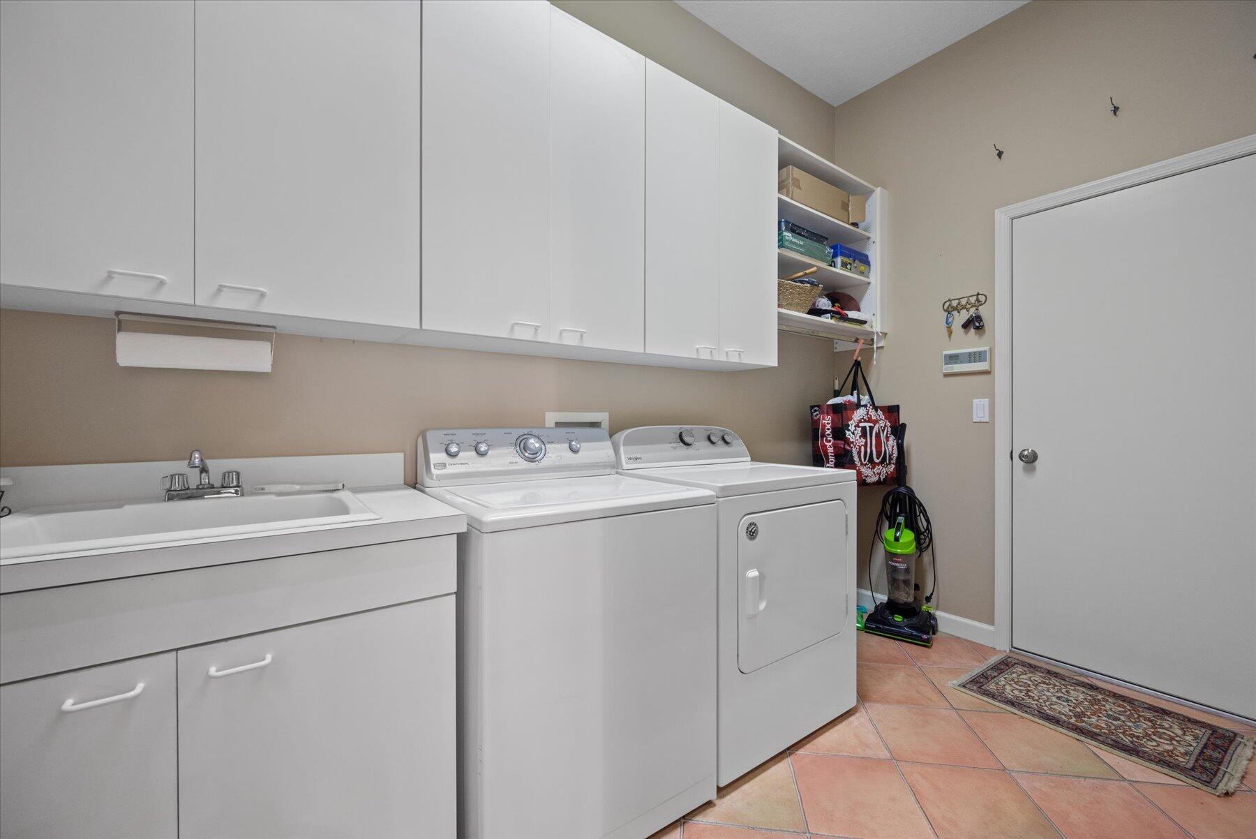 3498 Southeast Doubleton Drive Stuart, FL 34997 - Photo 26 of 42 a utility room with dryer and washer