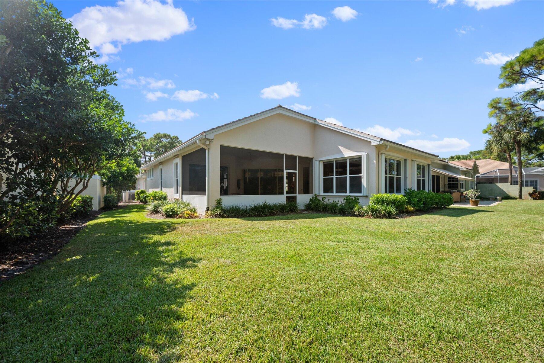 3498 Southeast Doubleton Drive Stuart, FL 34997 - Photo 28 of 42 a front view of a house with a garden