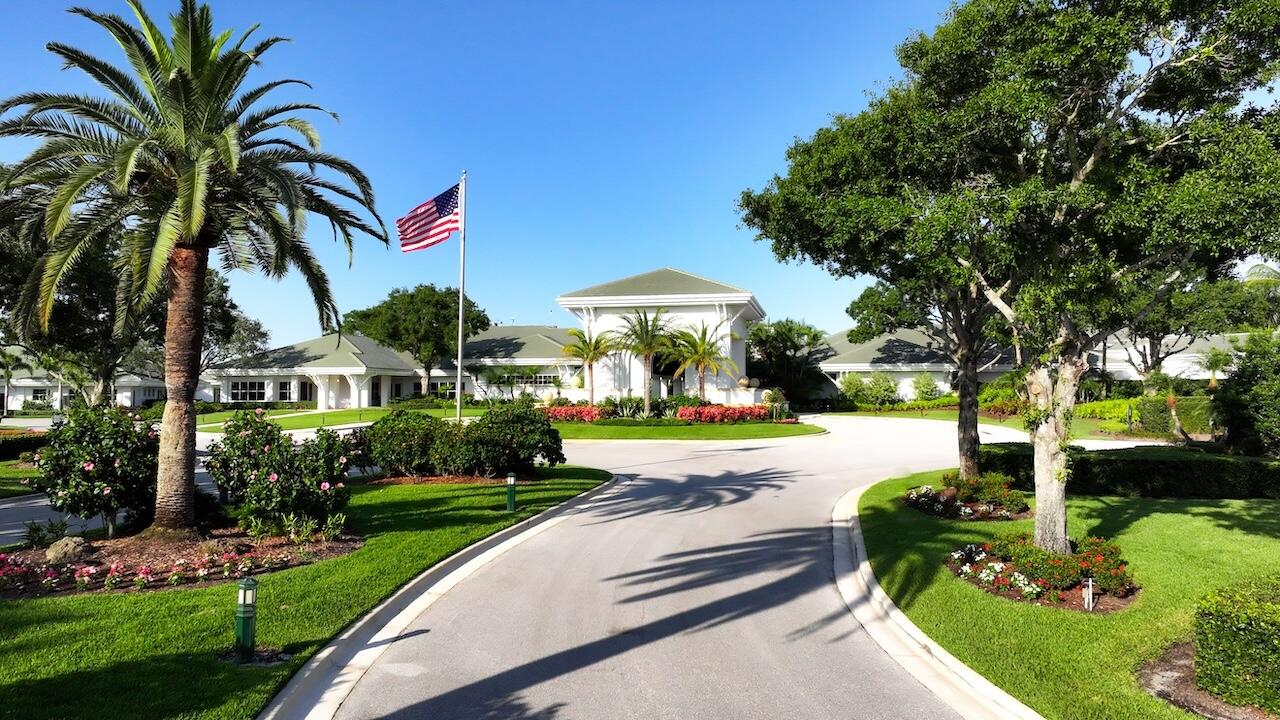 3498 Southeast Doubleton Drive Stuart, FL 34997 - Photo 35 of 42 a front view of a house with fountain and garden
