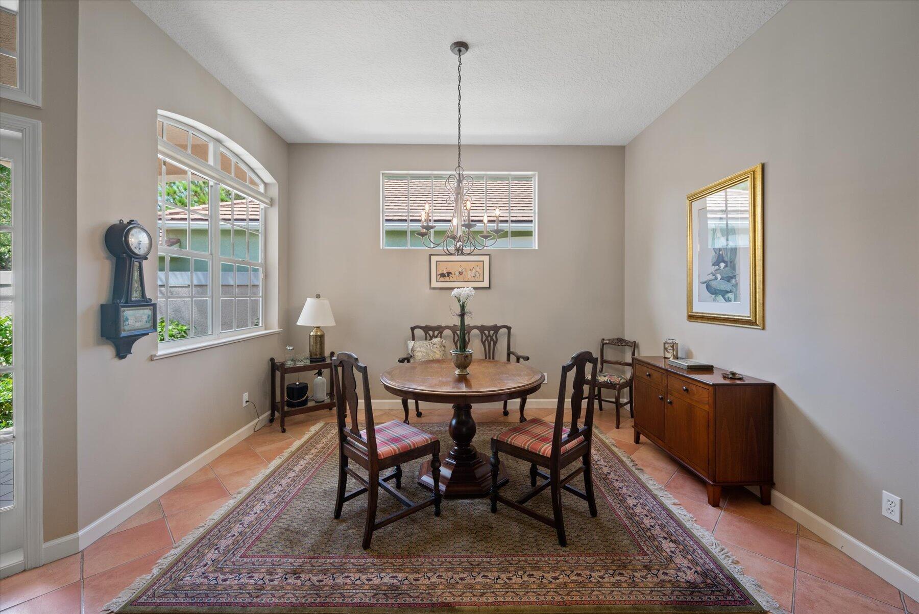 3498 Southeast Doubleton Drive Stuart, FL 34997 - Photo 6 of 42 a dining room with furniture a rug and wooden floor