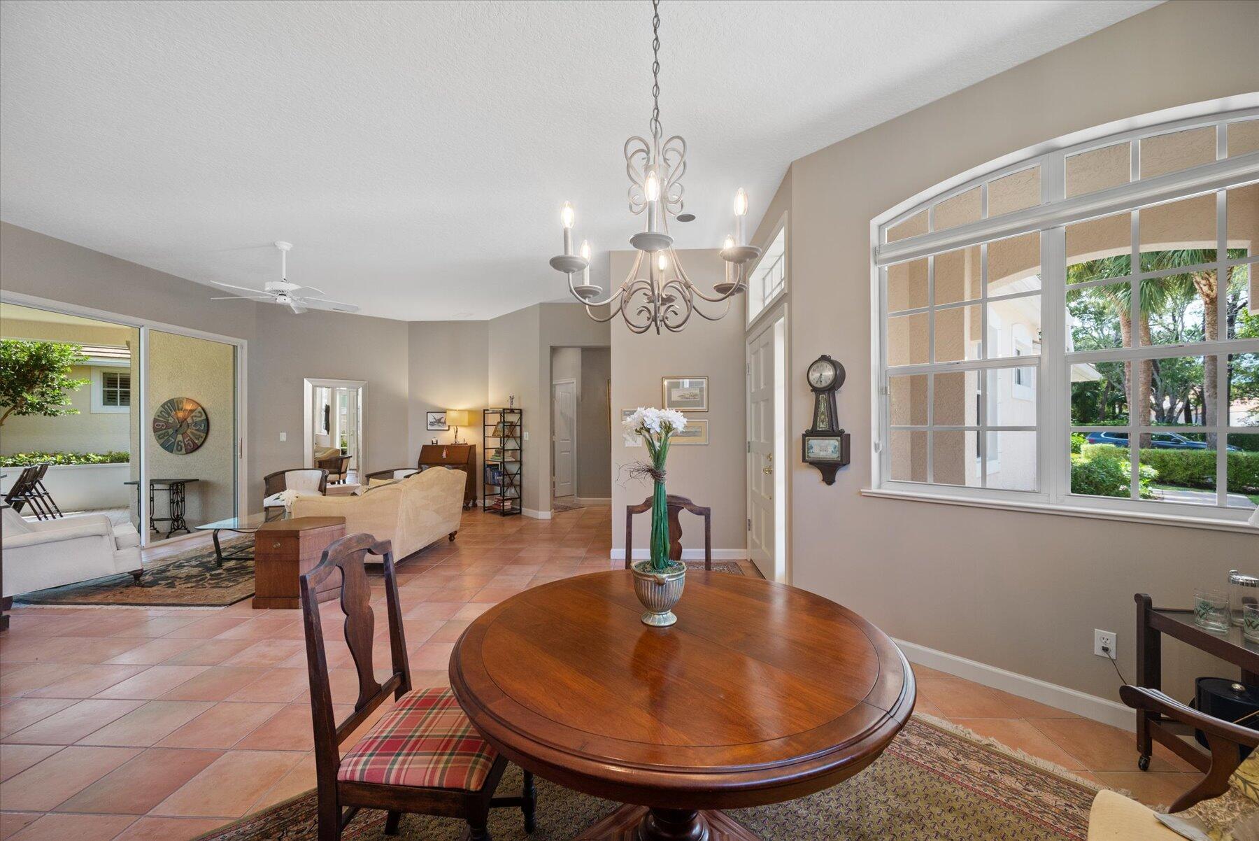 3498 Southeast Doubleton Drive Stuart, FL 34997 - Photo 7 of 42 a dining room with chandelier and wooden floor