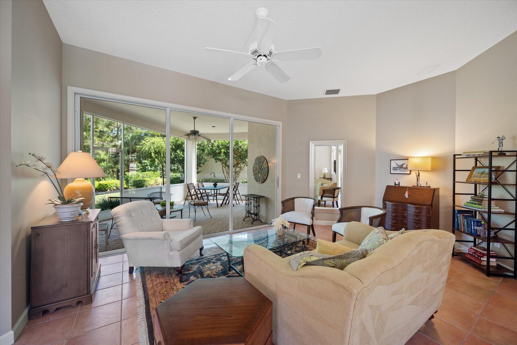 3498 Southeast Doubleton Drive Stuart, FL 34997 - Photo 8 of 42 a living room with furniture and a large window