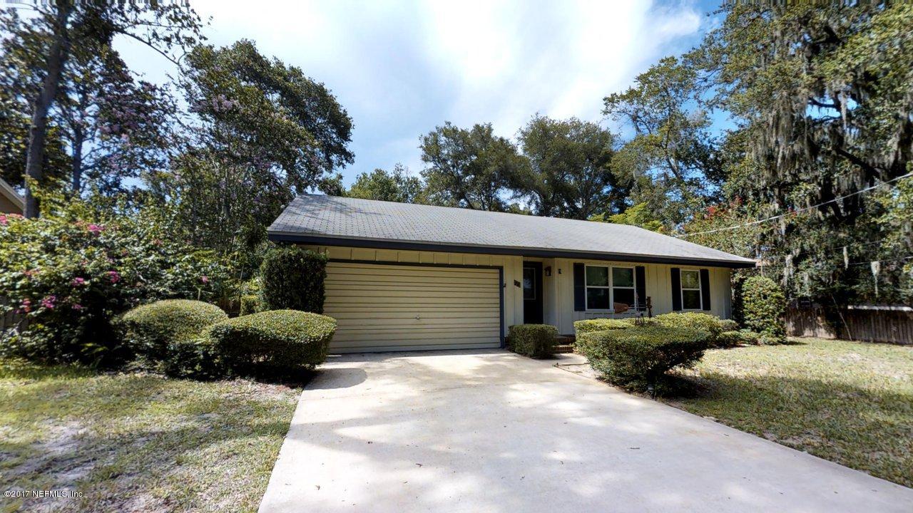 121 Osage Road St. Augustine, FL 32086 - Photo 1 of 23 a front view of a house with a garden and trees