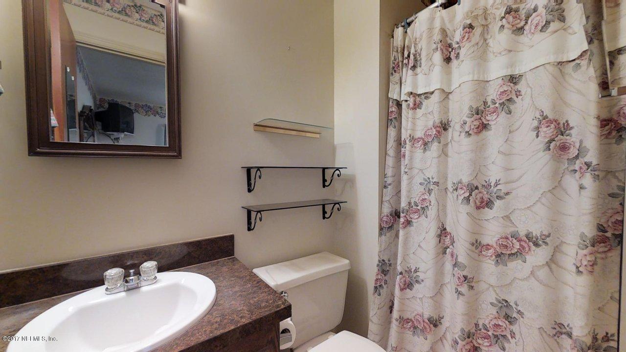 121 Osage Road St. Augustine, FL 32086 - Photo 14 of 23 a bathroom with a sink toilet and a mirror