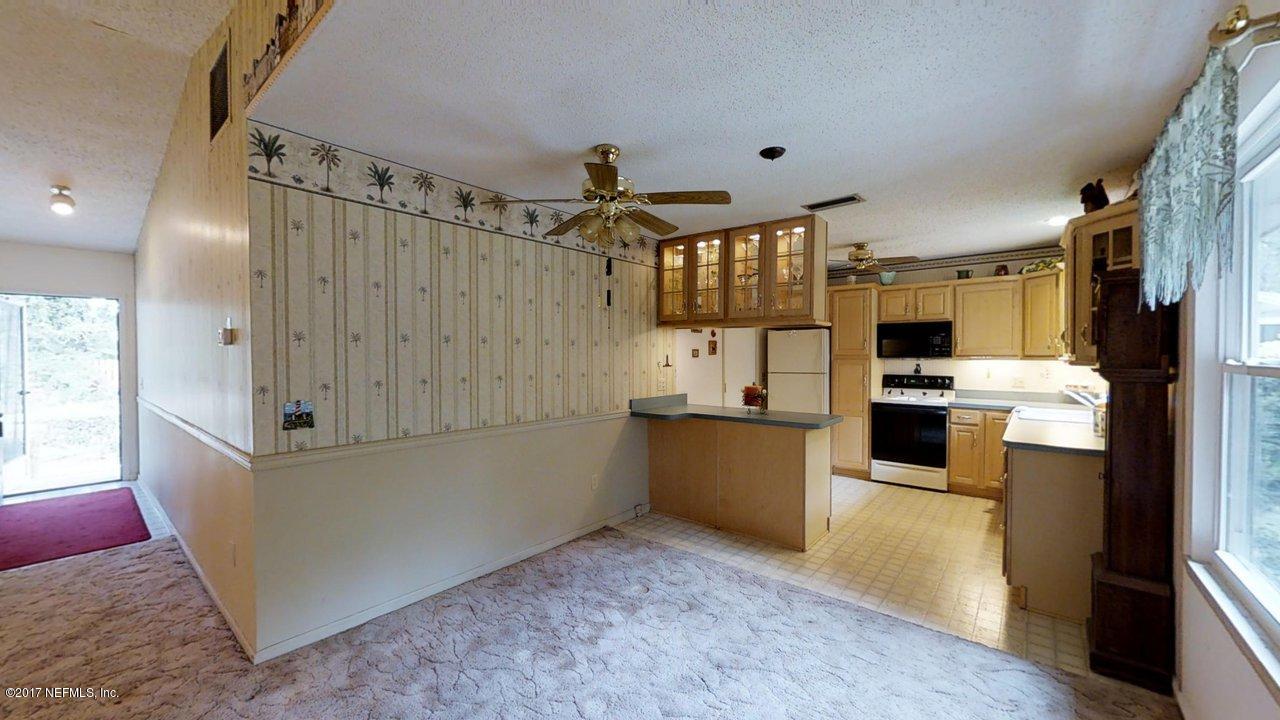 121 Osage Road St. Augustine, FL 32086 - Photo 2 of 23 a kitchen with cabinets and refrigerator