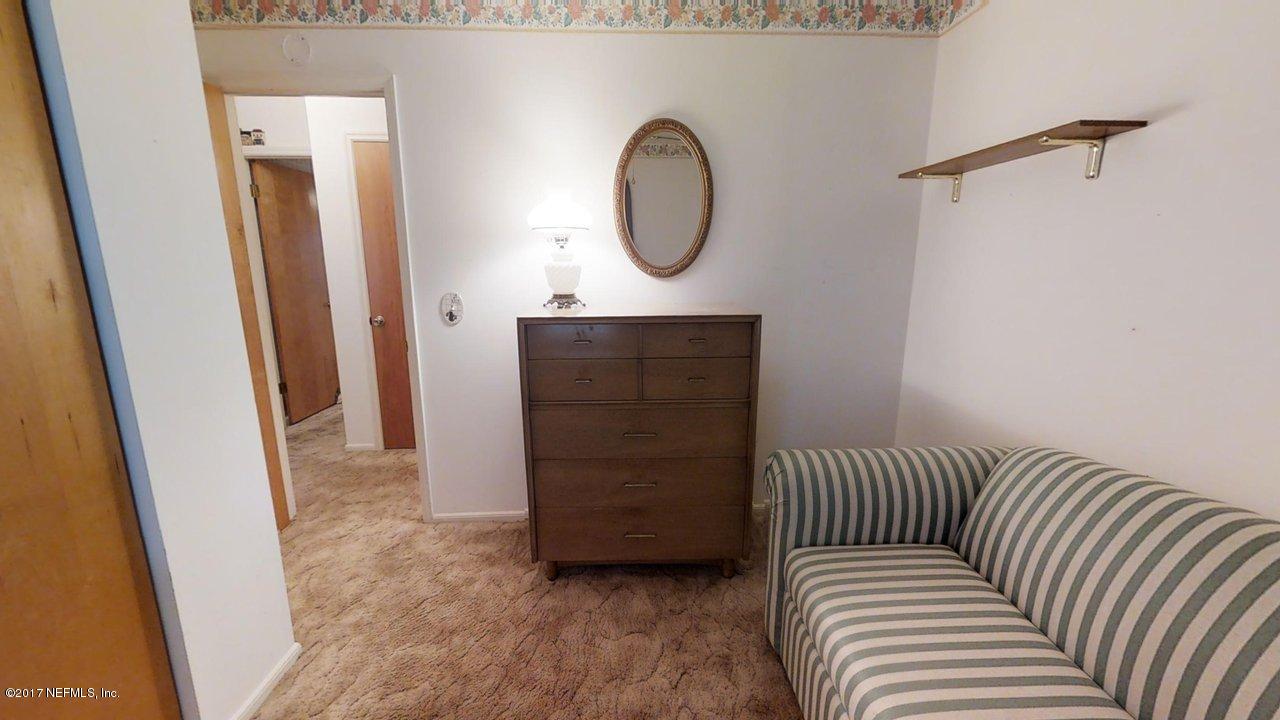 121 Osage Road St. Augustine, FL 32086 - Photo 10 of 23 a bedroom with a bed and a mirror