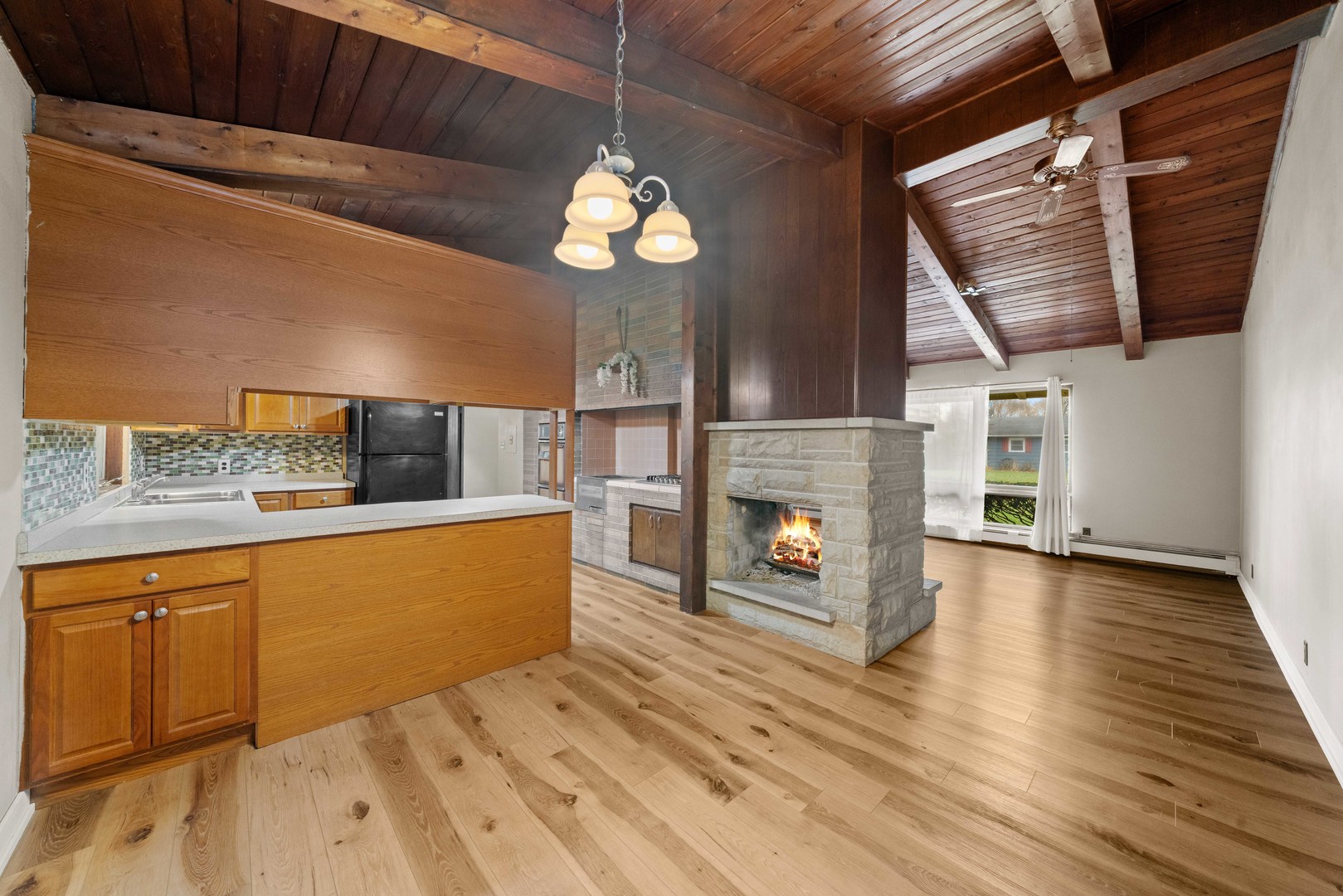 707 East Prairie Street Plano, IL 60545 - Photo 7 of 30 a view of a kitchen with a sink and a fireplace