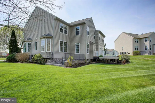 a view of a house with a yard and sitting area