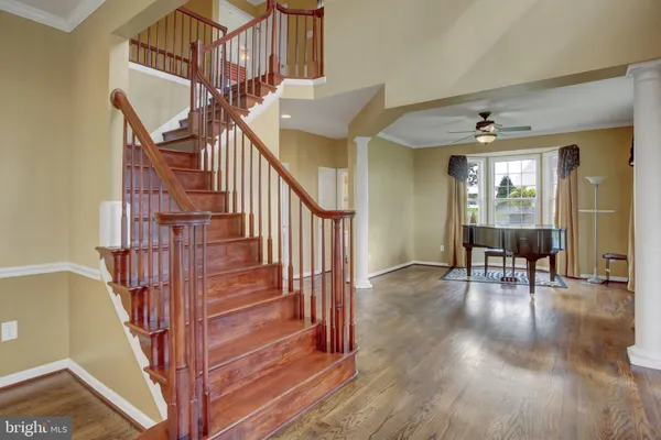 a view of entryway and hall with wooden floor