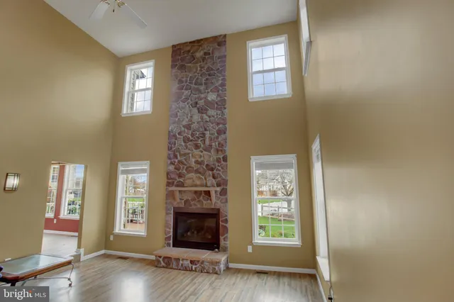 a view of a kitchen with stainless steel appliances wooden floor and chair
