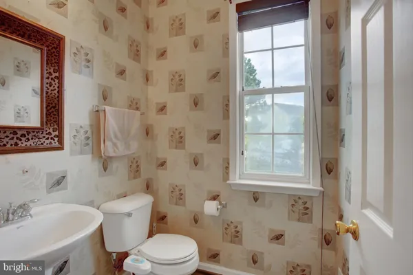 a white toilet sitting next to a bathroom sink