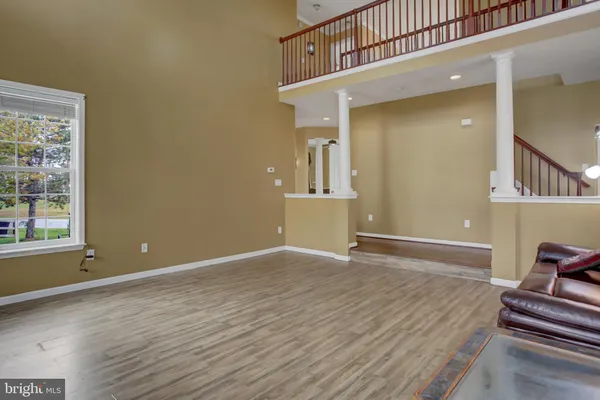 a kitchen with stainless steel appliances granite countertop a refrigerator a sink a stove and a wooden floors