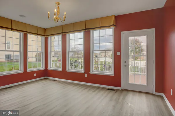 a living room with furniture a fireplace and a floor to ceiling window