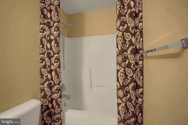 a view of a balcony with two chairs and wooden floor