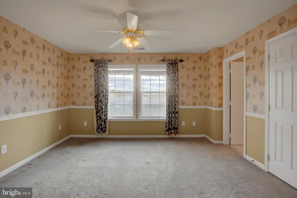 a view of a hallway with wooden floor and stairs