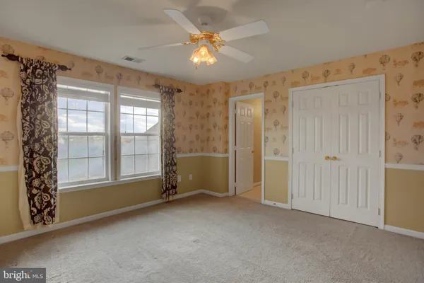 a view of a livingroom with wooden floor and a fireplace