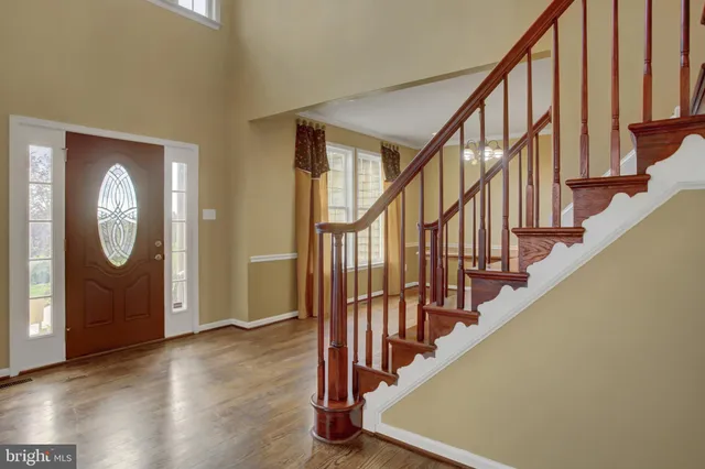 a view of an entryway with wooden floor and door