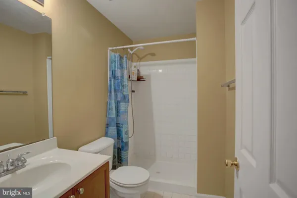 an aerial view of a house with a garden and lake view