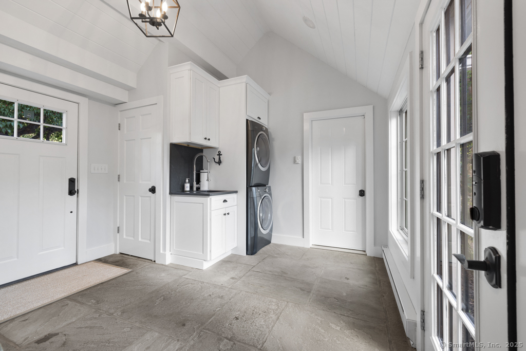 93 East Meadow Road Wilton, CT 06897 - Photo 16 of 35 a view of a hallway with wooden cabinet and door
