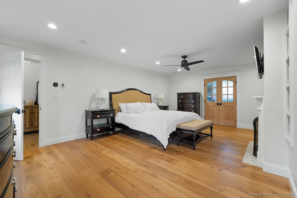 93 East Meadow Road Wilton, CT 06897 - Photo 19 of 35 a bedroom with a bed and wooden floor