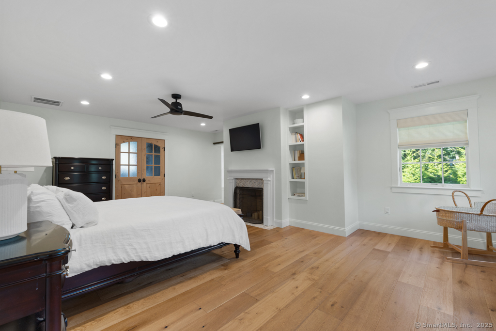 93 East Meadow Road Wilton, CT 06897 - Photo 20 of 35 a bedroom with a bed and a fireplace