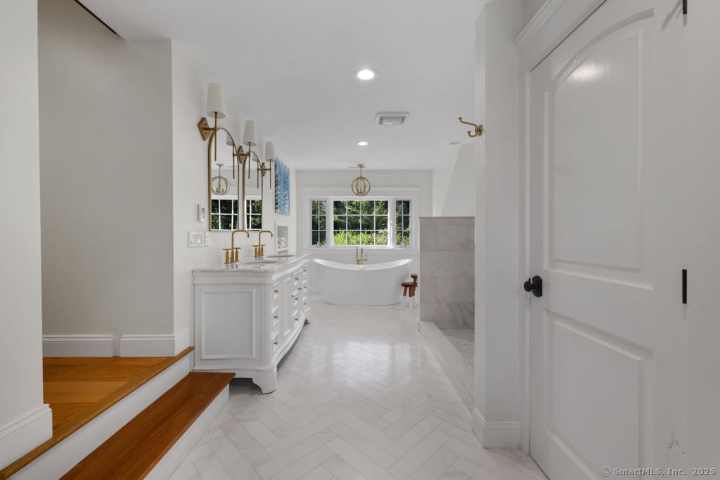93 East Meadow Road Wilton, CT 06897 - Photo 21 of 35 a bathroom with a tub sink and mirror