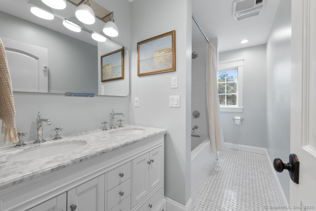 93 East Meadow Road Wilton, CT 06897 - Photo 27 of 35 a bathroom with a granite countertop sink a mirror and a shower