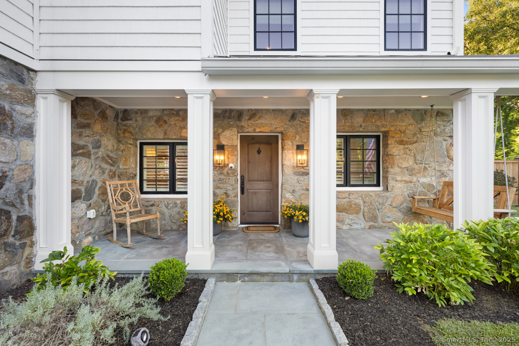 93 East Meadow Road Wilton, CT 06897 - Photo 4 of 35 a view of front door of house with outdoor seating
