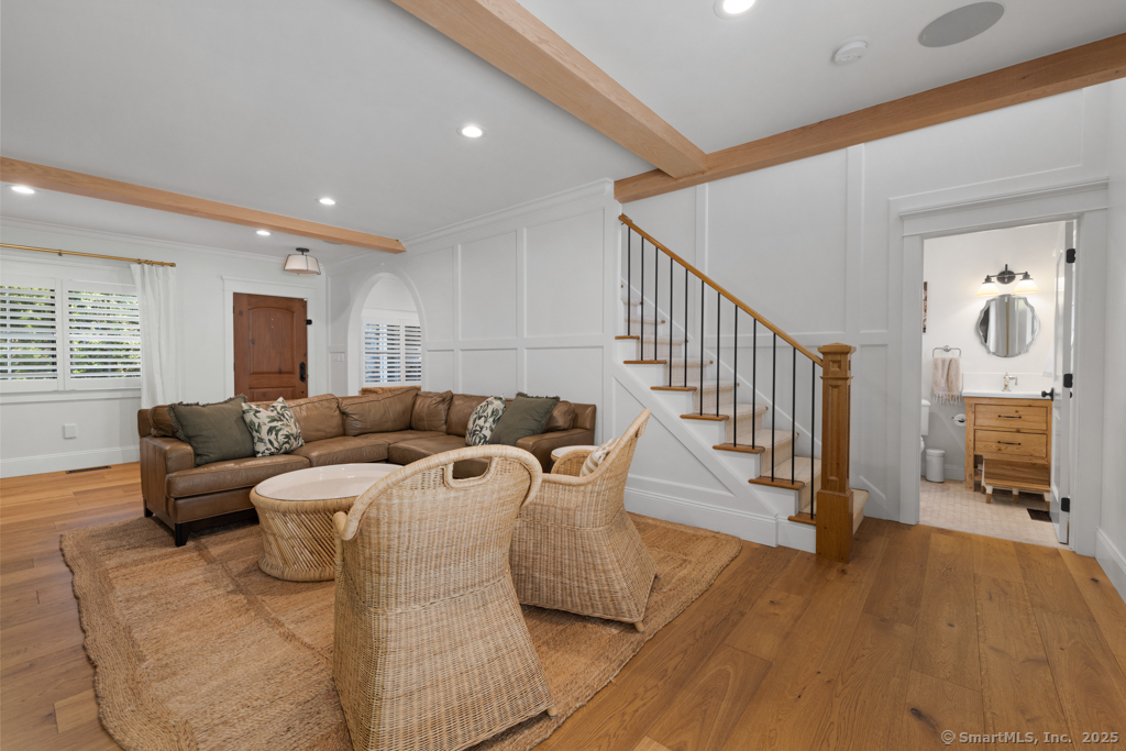93 East Meadow Road Wilton, CT 06897 - Photo 6 of 35 a living room with furniture a fireplace and a flat screen tv