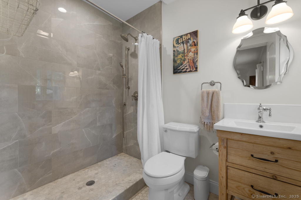 93 East Meadow Road Wilton, CT 06897 - Photo 7 of 35 a bathroom with a shower a sink and a toilet