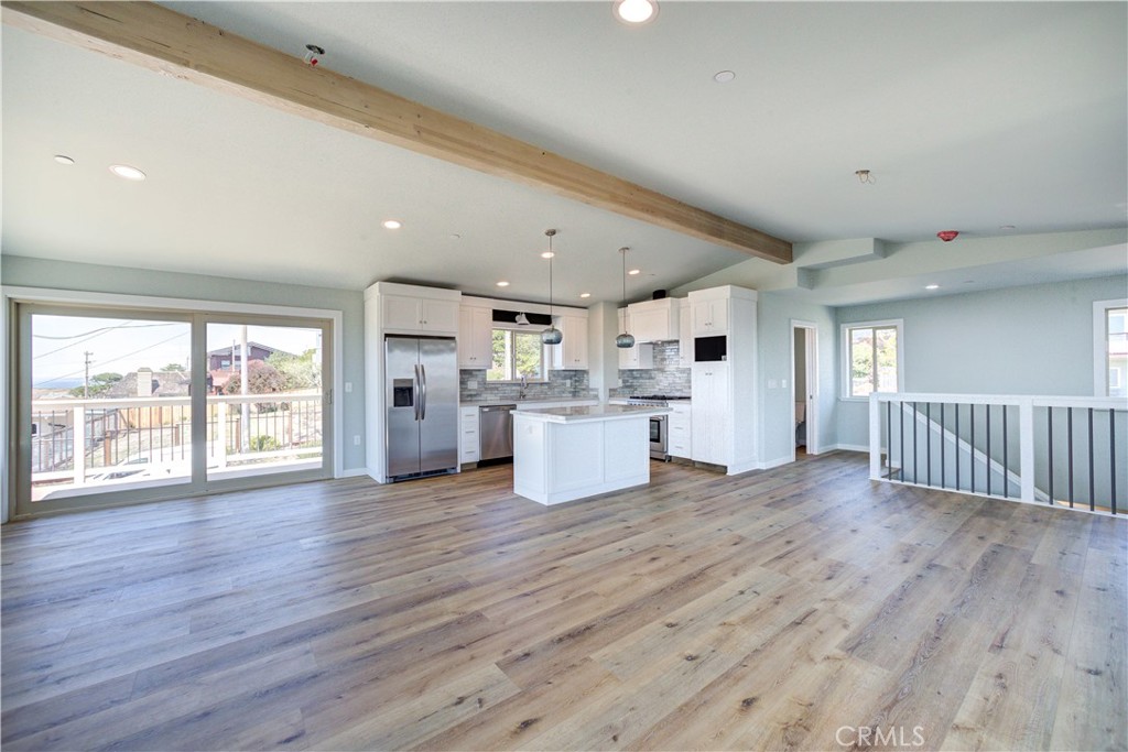 396 Castle Street Cambria, CA 93428 - Photo 17 of 74 a view of a kitchen with wooden floor and a window