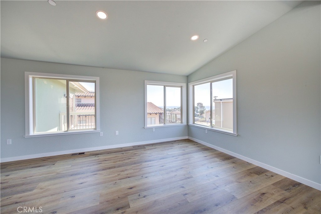 396 Castle Street Cambria, CA 93428 - Photo 20 of 74 a view of an empty room with wooden floor and a window