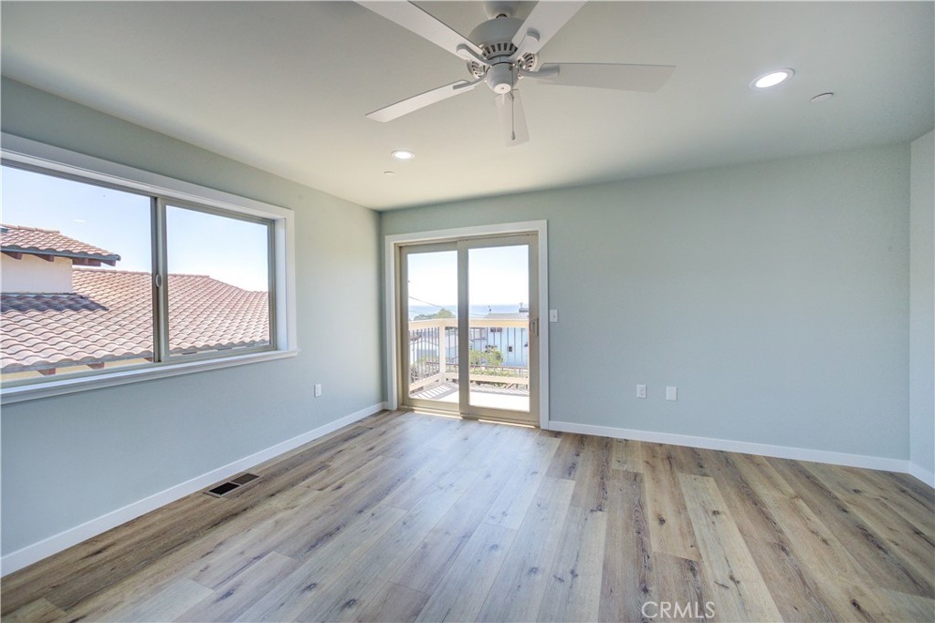396 Castle Street Cambria, CA 93428 - Photo 29 of 74 wooden floor in an empty room with a window