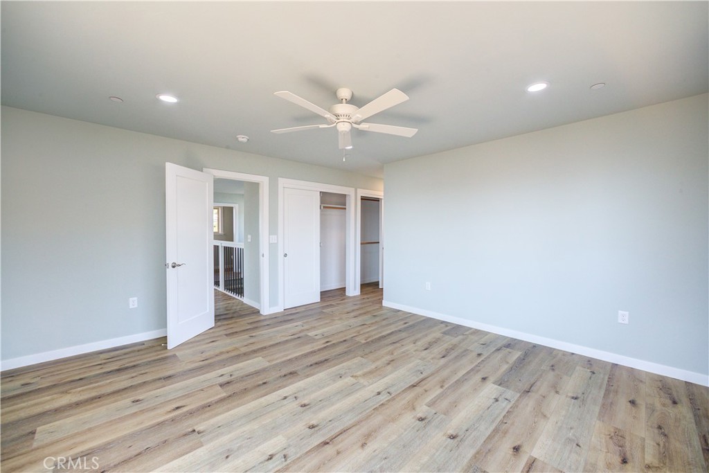 396 Castle Street Cambria, CA 93428 - Photo 31 of 74 a view of an empty room with wooden floor and a ceiling fan