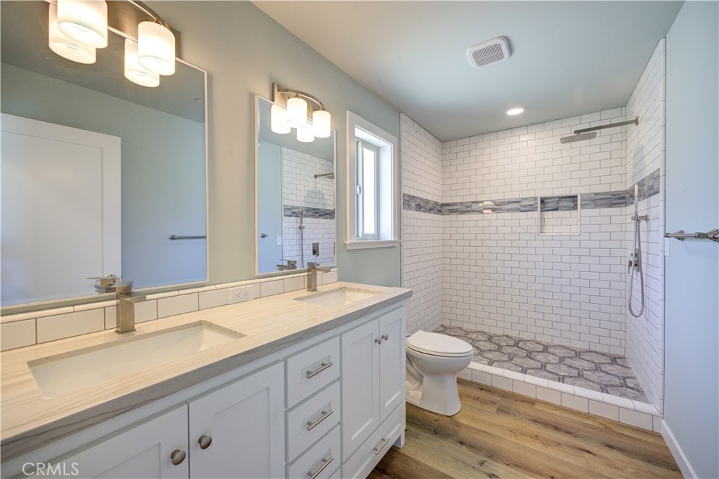 396 Castle Street Cambria, CA 93428 - Photo 33 of 74 a bathroom with a double vanity sink toilet and shower